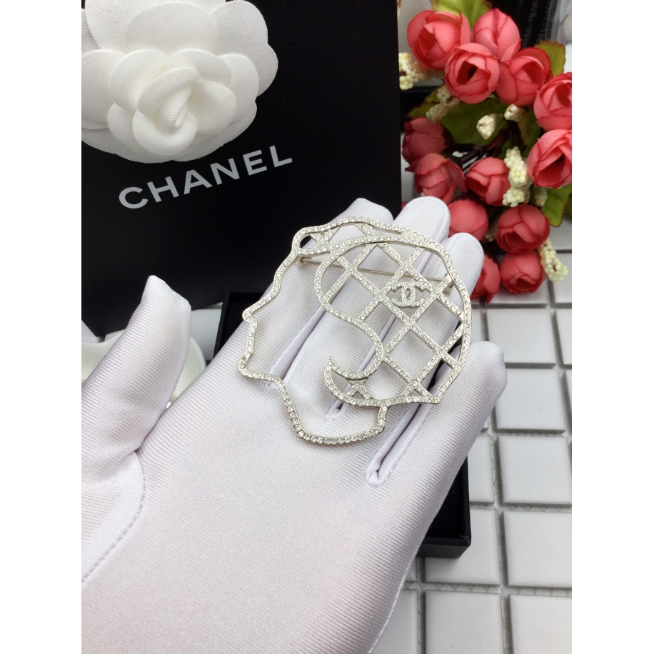 Золотая брошка Chanel камни